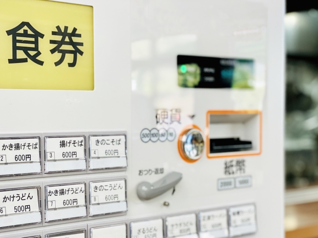 White ticket vending machine, common in most ramen shops.   