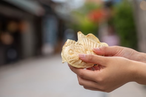 Close-up of a person holding a taiyaki