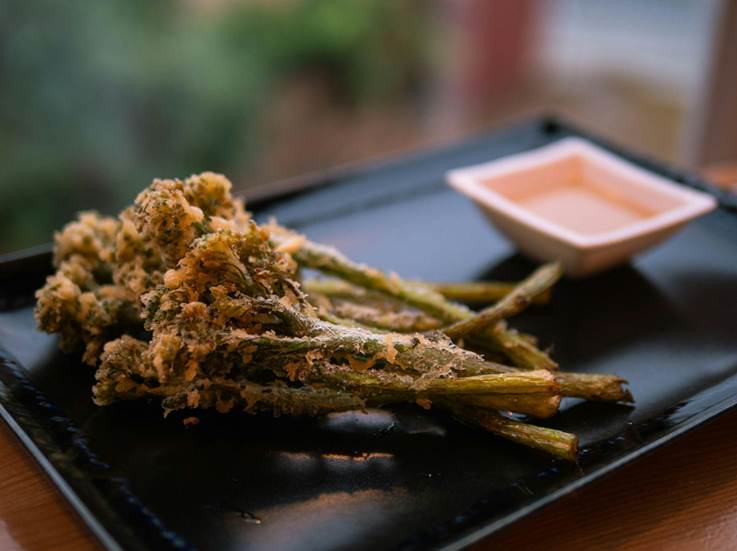 Fried tempura with a small plate of sauce on the side.