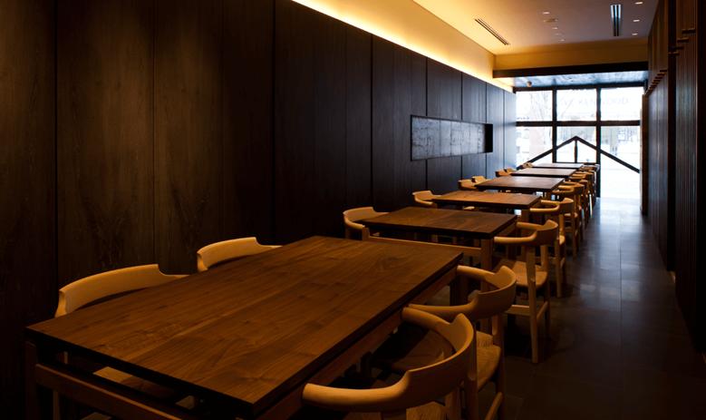 Warm interior with dark wood and ambient lighting at Ippodo Chaho.