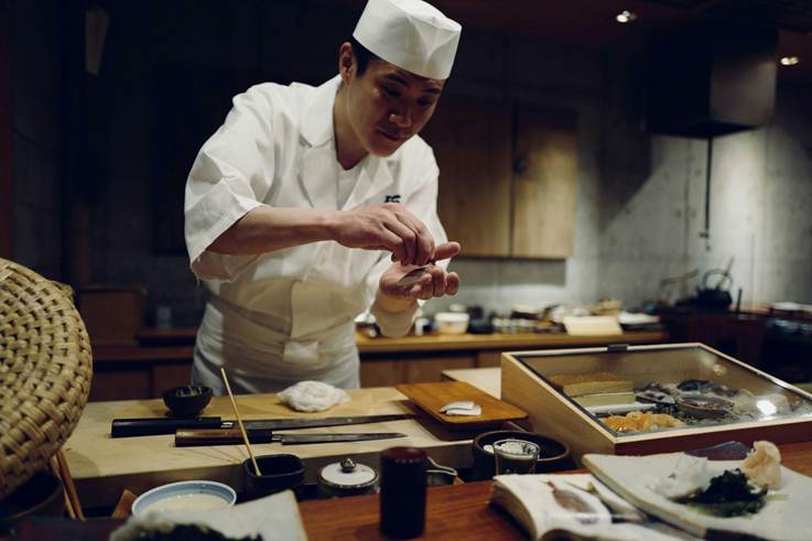 A chef making sushi.